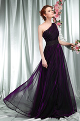 Fototapeta premium Beautiful sexual redheaded girl in evening dress 