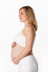 Studio Portrait Of 6 months Pregnant Woman Wearing White