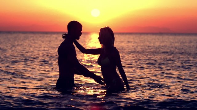 Couple Kissing At Sunset