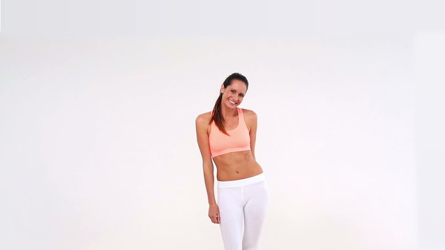 Fit model laughing and smiling at camera with exercise balls