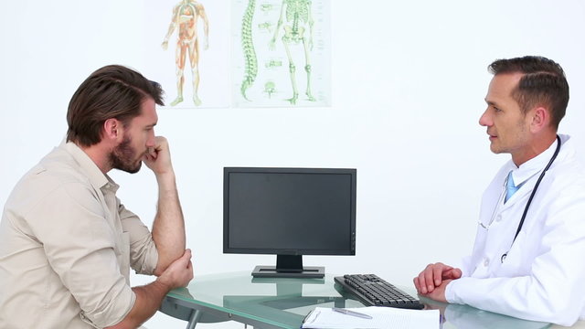 Patient talking with his doctor about injured elbow