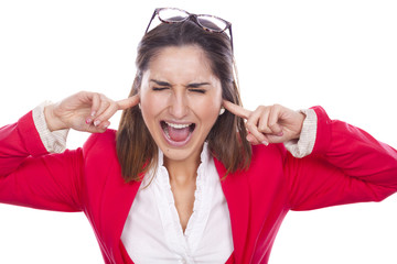 Portrait of a unhappy young woman covering her ears and screamin