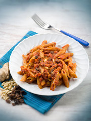 pasta with tomatoes dried grape and pine nuts, selective focus