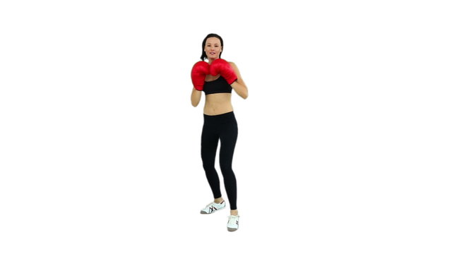 Fit brunette boxing with red gloves