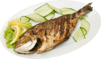 Grilled fish sea bream on BBQ with vegetables