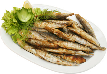 Grilled small fishes on BBQ with vegetables 