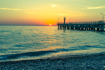 sea ​​and a pier at sunset