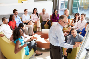 Businessman Making Presentation To Office Colleagues