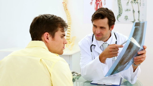 Young doctor showing xray to his patient
