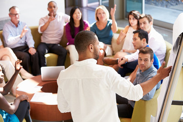 Businessman Making Presentation To Office Colleagues