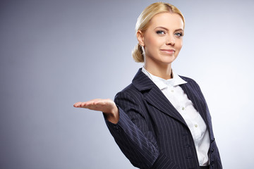 businesswoman presenting something on grey background