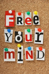 The phrase Free Your Mind on a cork notice board