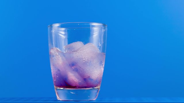 Melting ice cubes in a glass time lapse