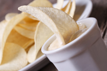 Potato chips in a white sauce on the old table