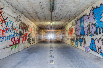 narrow tunnel with graffiti
