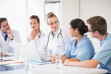 Team of doctors and nurses discussing