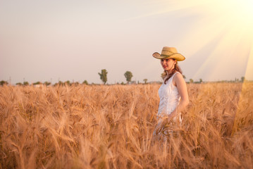 Naklejka na ściany i meble Woman in the wheat field