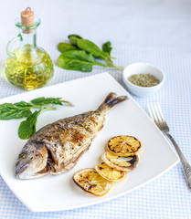 Grilled dorada fish with lemon and spinach