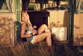 beautiful girl on an old caravan