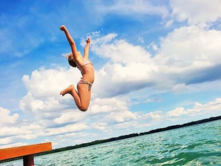 Girl jumping into the lake.