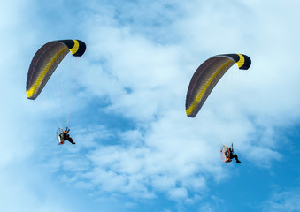 Paragliding fly on blue sky