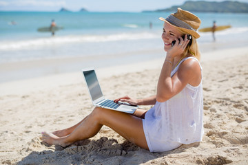 Caucasian business woman on beach cellphone