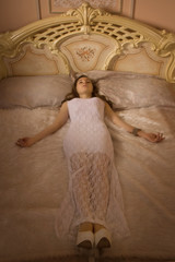 Young elegant girl lying on the bed