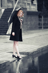 Woman with umbrella walking in the rain