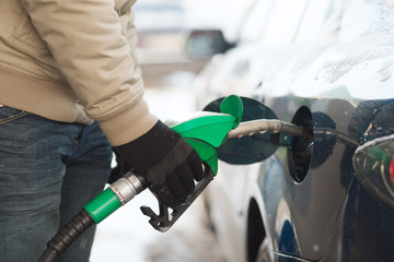 close up of male refilling car fuel tank