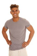 Obraz premium man in gray striped shirt hands hips smiling