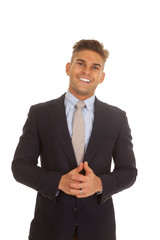 man in suit coat smile hands clasped