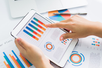 Close-up of  business person using digital tablet with financial