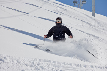 Skier in deep powder, extreme freeride