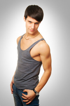 Sporty and healthy muscular man on gray background