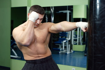 Boxer with gloves on training in the gym