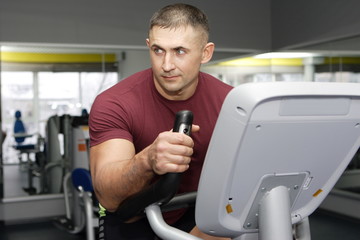 Bodybuilder trains on a stationary bike