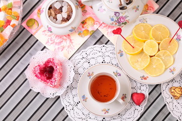 Obraz na płótnie Canvas Warm cup of tea and sweets