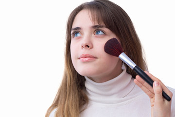 Obraz premium portrait of a girl with a brush for makeup near her face