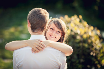 girl tenderly embraces her boyfriend
