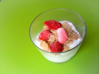 Healthy dessert bowl with red berries yogurt and cereals