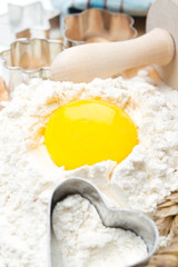 baking - flour, eggs, rolling pin and baking forms, close-up