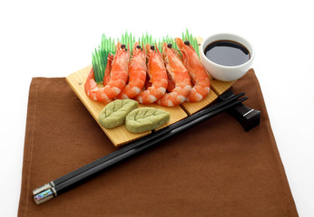 Sashimi with shrimp, wasabi and marinated ginger on wooden plate