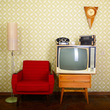 Vintage room with wallpaper, old fashioned armchair, tv, phone,