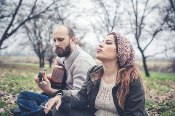 couple in love playing serenade with guitar