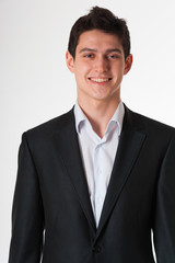 Young smiling business man in suit on white background