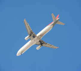 Large passenger aircraft in flight against blue sky