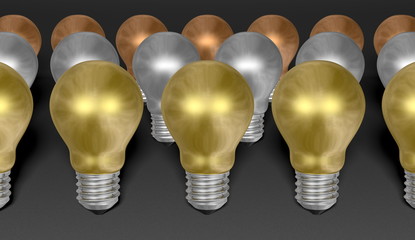 Rows of golden, silver and bronze light bulbs on grey background