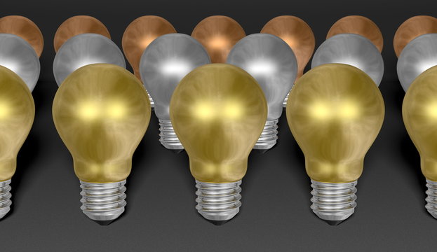 Rows of golden, silver and bronze light bulbs on grey background