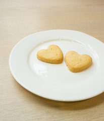 Heart cookies on white plate .Space for text