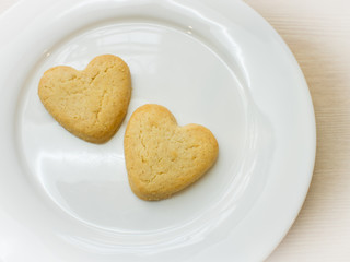 Heart cookies on white plate .Space for text